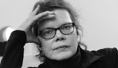 Black and white headshot of artist, curator, editor, and writer Julie Ault. Photographed by Grace Roselli.
